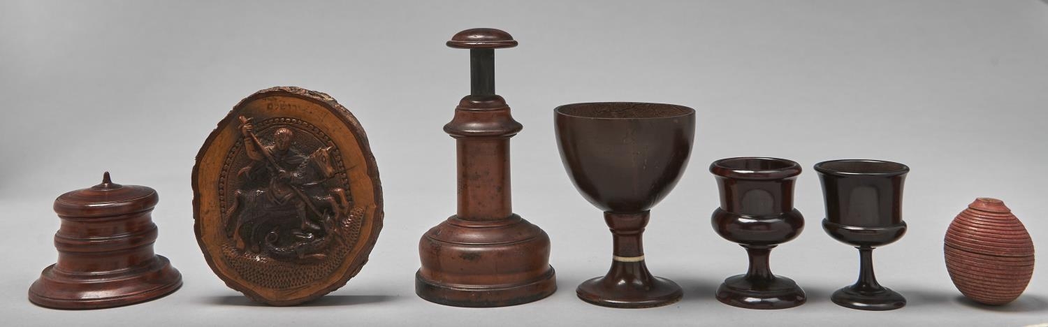 A group of treen objects, comprising an ornamental turned boxwood wide based jar and cover, early
