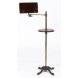 A Victorian brass and mahogany adjustable music stand, c1890-1900, the ornate cast iron base with