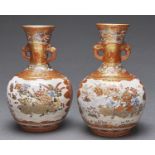 A pair of Japanese Kutani vases, Meiji period, of bottle shape with mask handles to the flared neck,