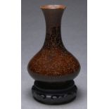 A Chinese speckled lustrous brown glazed vase, with flared neck, 18.5cm h, wood stand Rim chipped