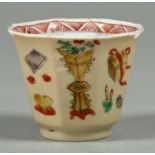 A Chinese octagonal famille verte beaker, 18th c, enamelled with auspicious objects over a pale faun