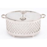 A George V two handled and pierced oval silver dish and cover, with earthenware liner, 12.5cm over