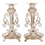 A pair of Edwardian silver flower stands, the detachable vase within a frame of three scrolling