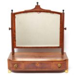 A Regency mahogany dressing table mirror, c1820, the arched bevelled plate within cross grained