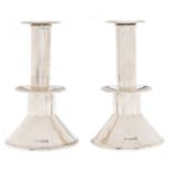 A pair of George V silver candlesticks, with low drip pan and conical foot, nozzles, 13.5cm h, by