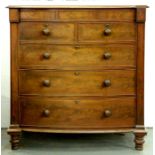A Victorian mahogany bow front chest of drawers, the top with moulded lip above central blind drawer