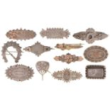 Twelve Victorian and Edwardian silver brooches, including round, oval, horseshoe shaped and other