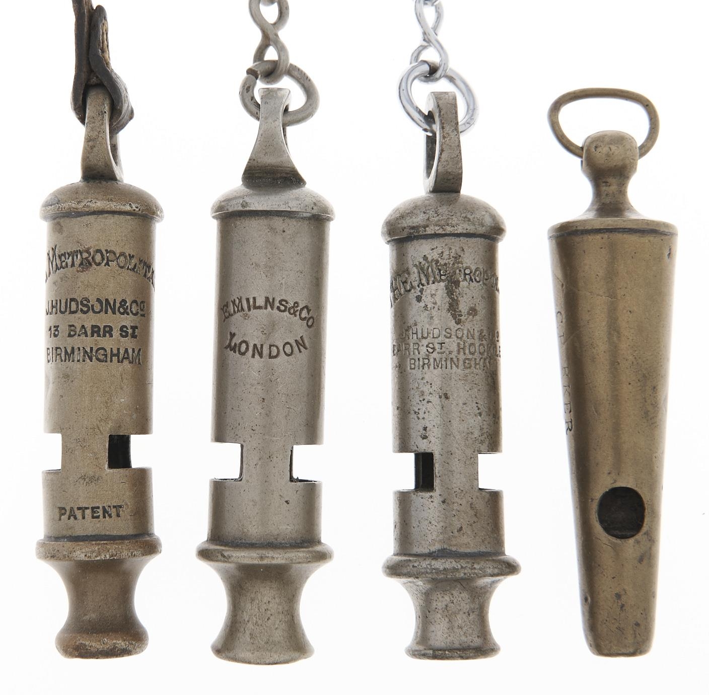 Two J D Hudson & Co Metropolitan whistles, a similar whistle and a brass whistle, late 19th /