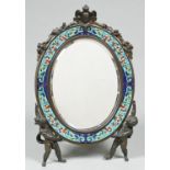 A French gilt bronze and champleve enamel easel mirror, late 19th c, the bevelled oval plate