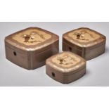 A graduated set of three Japanese inlaid lacquer boxes, Meiji period, the lid decorated with