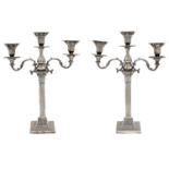 A pair of Edwardian EPNS  three light candelabra,  with beaded drip pans and scrolling branches,