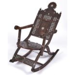 A Syrian ivory and mother of pearl inlaid and carved wood rocking chair, late 19th c, with round