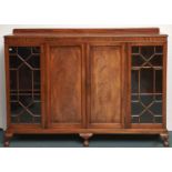 A mahogany side cabinet, c1930, the central panel door flanked by thirteen pane glazed doors