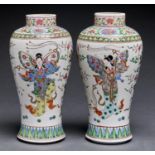 A pair of Chinese famille rose vases,  decorated with butterfly winged ladies, 28cm h Crack in