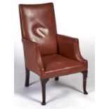 A brass nailed tan leather upholstered library chair, 19th / early 20th c, on lappeted mahogany