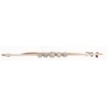 A five stone diamond bar brooch, early 20th c, set in line on knife wire, in gold, 3.2g Good