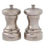 Two Elizabeth II silver pepper mills, 10cm h, by Carrs Sheffield, 2007 and 2008 Good condition