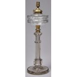 An Edwardian columnar cut glass oil lamp and detachable fount, with brass fitment, on stepped star