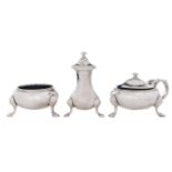 A George V three piece silver condiment set, on hoof feet, blue glass liners, pepperette 90mm h,