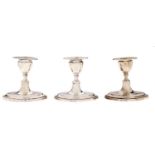 One and a pair of Edwardian silver dwarf navette shaped candlesticks, nozzles, 90mm h, by Thomas A