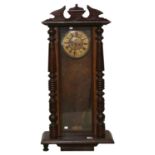 A walnut and stained wood Vienna wall clock, c1900, pendulum and two brass sleeved weights, 103cm