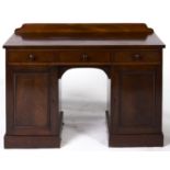 A Victorian plum pudding mahogany dressing table, c1850, with shaped upstand and figured top, fitted