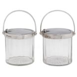 A pair of George V patent self-opening silver mounted glass jam or honey jars, 12cm h, by The