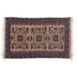 A Persian style blue bordered rug with fawn field, 84 x 143cm Good condition
