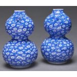 A pair of Japanese blue and white Seto ware double gourd vases, Taisho period, decorated with