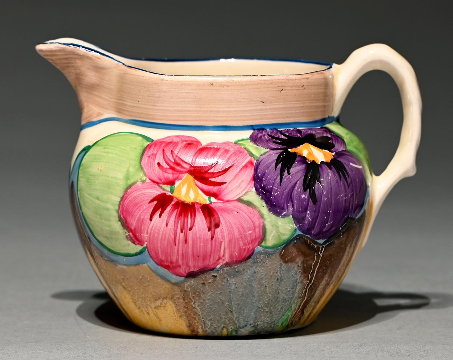 Clarice Cliff. An A J Wilkinson Pansies jug, 1932, 90mm h, printed marks, painted PANSIES Good