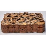 A Continental carved softwood box, late 19th c, of serpentine form, the lid carved in high relief