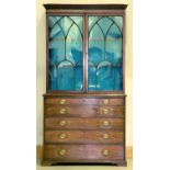 A George III mahogany secretaire bookcase, c1790, with dentil moulded flared cornice above a shallow