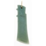 A South East Asian jade axe head pendant, suspended from a gold hook Good condition, one face of the