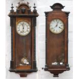 Two walnut and ebonised Vienna wall timepieces, c1900, with enamel dial, gridiron pendulums, 75cm