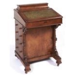 A Victorian walnut Davenport, c1880, crossbanded and line inlaid, with spiral turned pillars and bun