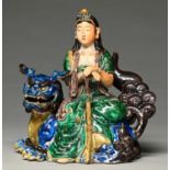 A Japanese porcelain figure of the Manjushri (Monju Bosatsu), Meiji period, seated on the back of