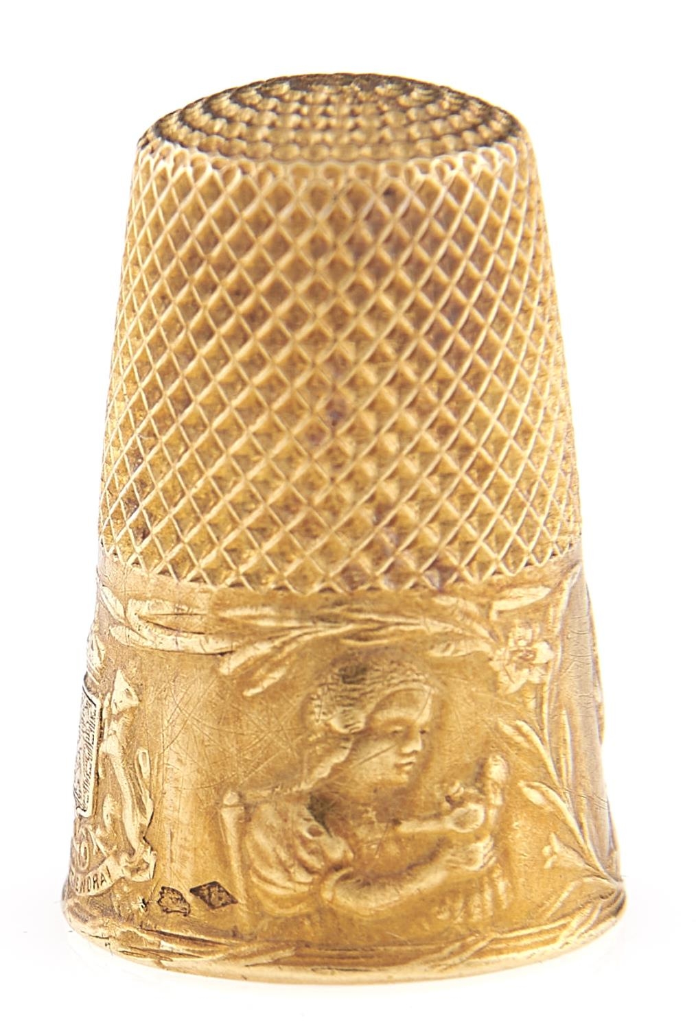 A French gold thimble, c1900, embossed with the heads of children and coat of arms, 24mm, maker's