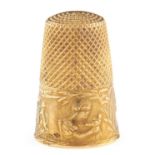 A French gold thimble, c1900, embossed with the heads of children and coat of arms, 24mm, maker's