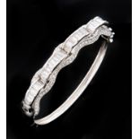 A gem set white gold bangle, foreign control mark, 24.9g Good condition with a few light scratches