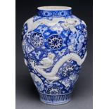 A Japanese blue and white Imari vase, moulded in shallow relief with dragons, 44cm h Good condition