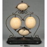 An Australian brass mounted emu egg and ostrich egg trophy or ornament, c1870, the scrolling frame