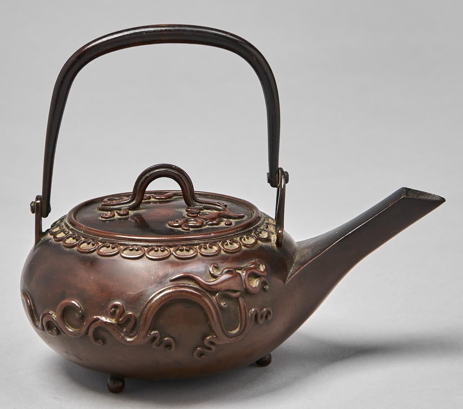 A Japanese bronze kettle and cover, Meiji period, of compressed form with straight spout, swing