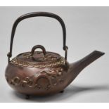 A Japanese bronze kettle and cover, Meiji period, of compressed form with straight spout, swing