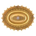 A Victorian 15ct gold oval brooch, gipsy set with central old cut diamond and filigree decorated,