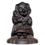 A Victorian cast iron Judy doorstop, modelled holding a diminutive Mr Punch in her arms, 28cm h Good