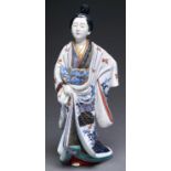 A Japanese Imari figure of a bijin, Meiji period, her kimono decorated in underglaze blue, overglaze