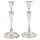 A pair of George VI silver candlesticks, in neo classical style, nozzles, 25cm h, by Northern