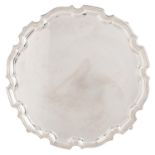 A George VI silver salver,  on four leaf capped volute feet, 35.5cm diam, by Charles Packer & Co