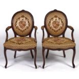 A pair of mahogany open armchairs, in so-called French "Hepplewhite" style, carved with pendant