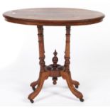 A Victorian oval walnut and inlaid table, c1880, the quarter veneered top on quadruple uprights